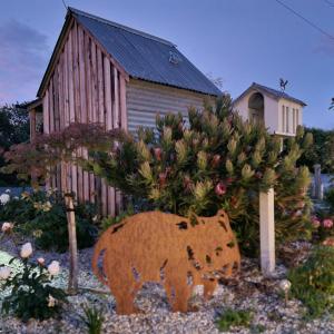 a statue of a bear in front of a christmas tree at Kadi House - Unit 1 in Wynyard +18 photos
