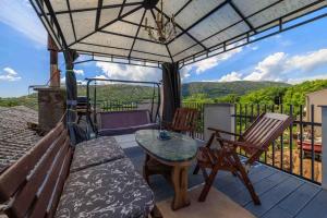 a patio with a table and chairs on a deck at Apartment in Bribir 50595 in Bribir
