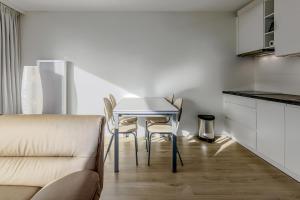 a kitchen and dining room with a table and chairs at Rietpanne 0106 in Koksijde
