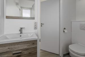 a bathroom with a sink and a toilet at Rietpanne 0106 in Koksijde