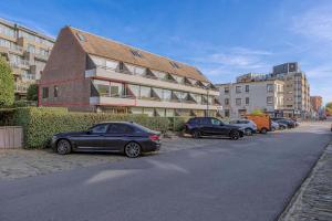 a row of cars parked in front of a building at Rietpanne 0106 in Koksijde +4 photos