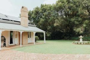 a house with a grassy yard with a fountain at Luxe Hinterland Stay, Eastnor at Montville Estate in Montville +23 photos