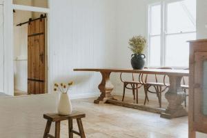 a dining room with a table and a vase on it at Luxe Hinterland Stay, Eastnor at Montville Estate in Montville