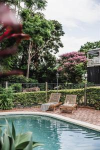 two chairs sitting next to a swimming pool at Luxe Hinterland Stay, Eastnor at Montville Estate in Montville +23 photos