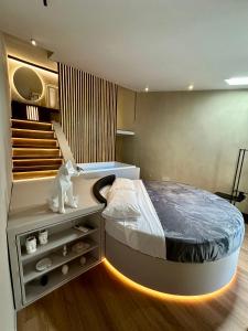 a bedroom with a large bed with a staircase at Renard Suite in Cefalù +23 photos