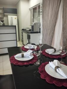 un tavolo con bicchieri da vino e tovaglioli sopra di Sobrado in the Central Region 1 suite 2 bedrooms a Foz do Iguaçu