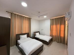 أجنحة هومينج ــ Homing Suites客房内的一张或多张床位