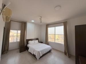 أجنحة هومينج ــ Homing Suites客房内的一张或多张床位