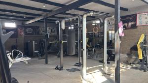 a gym with lots of equipment in a room at H Misión Sayula in Sayula