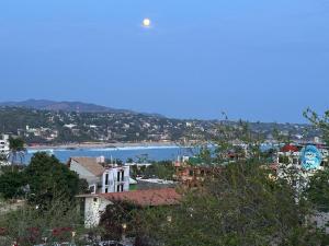 a view of a city and a body of water at Sicarú Suites in Puerto Escondido