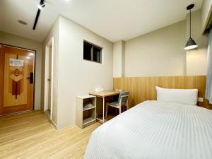 Ліжко або ліжка в номері Yoshi Hotel Xinmei Street
