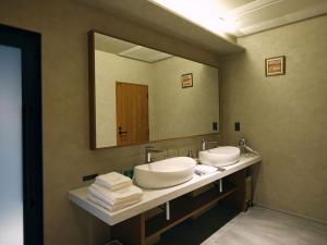 a bathroom with two sinks and a large mirror at The GOAT AWAJI in Kusumoto +63 photos