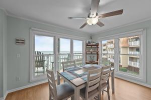 a dining room with a table and a ceiling fan at Sea La Vie- Oceanfront Family Retreat in North Topsail Beach