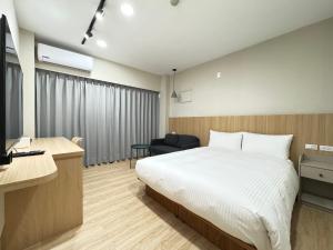 Ліжко або ліжка в номері Yoshi Hotel Xinmei Street