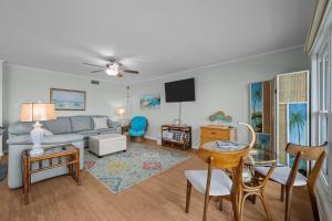 a living room with a couch and a table at Sea La Vie- Oceanfront Family Retreat in North Topsail Beach