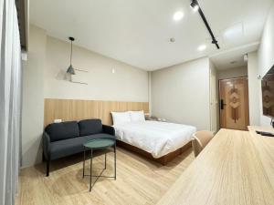 Ліжко або ліжка в номері Yoshi Hotel Xinmei Street