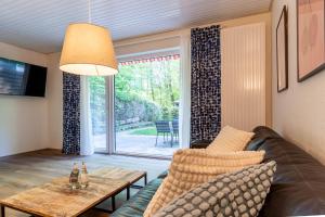 a living room with a couch and a table at Ferienwohnung mit Terrasse in St Peter-Ording Dorf – 1-Raum, EG, 45 m² in Ording