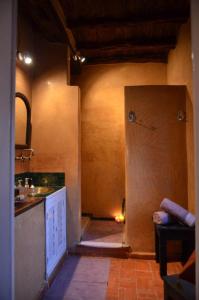a kitchen with a door leading into a room at Behind js in Essaouira