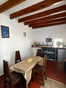 a dining room with a table and a kitchen at Behind js in Essaouira