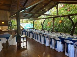 a long row of tables and chairs in a pavilion at Hostería los Cedros de Mindo in Mindo