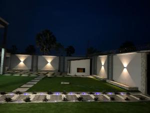 a house with lights on the facade at night at Minteh in Elephant Island