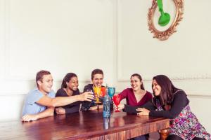 a group of people sitting around a wooden table at Lisbon Chillout Hostel Privates in Lisbon
