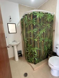 a bathroom with a shower with a bamboo shower curtain at Casa AmaNacer Malinalco in Loma San Felipe Santiago