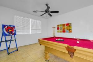 a room with a pool table and a ceiling fan at Game Room Pool King bed Pool Table in Peoria