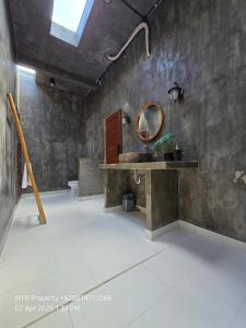 a bathroom with a sink and a mirror at Prime Location Villa Berawa Canggu 3bed in Canggu
