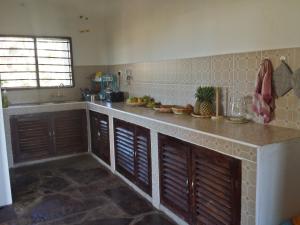 a kitchen with a counter top in a room at Anjumasa Village in Watamu