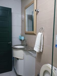 a bathroom with a sink and a mirror and a toilet at Hostel e pousada paz e benção in Mossoró +125 photos