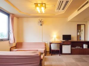 a hospital room with beds and a desk with a computer at Hotel Fukui Castle - Vacation STAY 58712v in Fukui