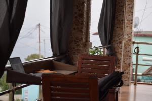 a room with two chairs and a table with curtains at Kumaon Gud Chaha Cafe & Homestay in Chaukori