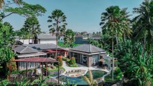 an aerial view of a house with palm trees at Coconut Grove 3BR Villa Pool Ubud in Ubud +35 photos
