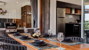 a dining room table with glasses and plates on it at Coconut Grove 3BR Villa Pool Ubud in Ubud