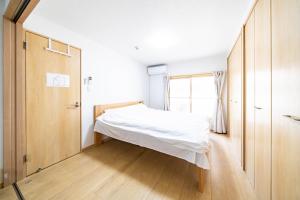 Ένα ή περισσότερα κρεβάτια σε δωμάτιο στο Torikari 5-chome1-10 鳥飼5丁目1-10