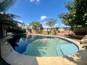 a swimming pool with blue water in a yard at Bello Bungalow in Batukliang