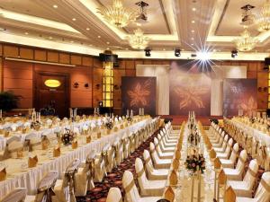 Un gran salón de banquetes con mesas y sillas blancas. en The Pavilion Hotel, en Shenzhen 253 fotos más