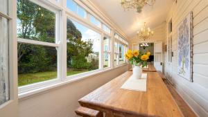 a hallway with a table with flowers in a vase at Secret Garden in Bowral