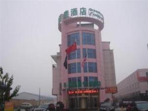 Un gran edificio con una bandera encima. en GreenTree Inn Linyi Bus Station, en Linyi