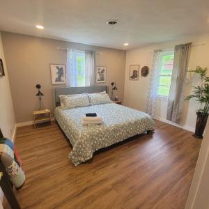 a bedroom with a bed with a wooden floor at NEW! VillaBella Luxury Farmhouse in Hermann