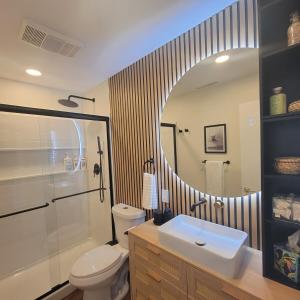 a bathroom with a toilet and a sink and a mirror at NEW! VillaBella Luxury Farmhouse in Hermann