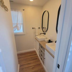 a bathroom with a sink and a mirror at NEW! VillaBella Luxury Farmhouse in Hermann +26 photos