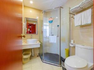 a bathroom with a shower and a toilet and a sink at GreenTree Inn Guangdong Huizhou Chenjiang Intercity Rail Station Business Hotel in Huizhou +185 photos