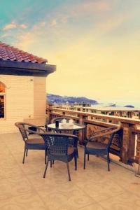 a patio with a table and chairs on a balcony at Putian Meizhou Island Lanhai Hotel in Putian