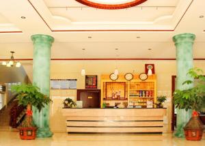 a lobby with a bar in a building with columns at Putian Meizhou Island Lanhai Hotel in Putian