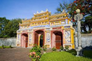 an ornate building withcriptions on it in a garden at Anh Tuan Guest House in Hue