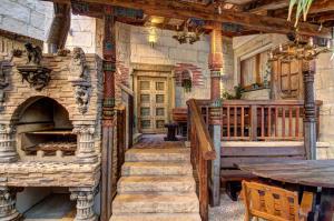 an old house with stairs and a table and a stone fireplace at Vaya Casa in Kappelrodeck