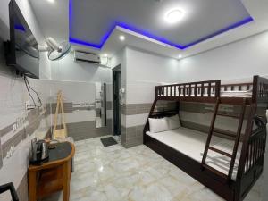 a room with two bunk beds and a sink at Ông 5 House in Can Tho +14 photos