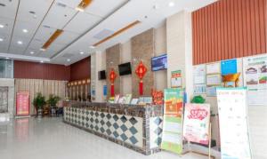 a grocery store with a counter in a building at GreenTree Inn Yancheng Dongtai Railway Station Beihai East Road Express Hotel in Xintuan
